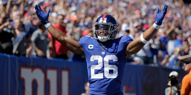 New York Giants' Saquon Barkley celebrates his touchdown during the first half of an NFL football game against the Buffalo Bills, Sunday, Sept. 15, 2019, in East Rutherford, N.J. (AP Photo/Adam Hunger)