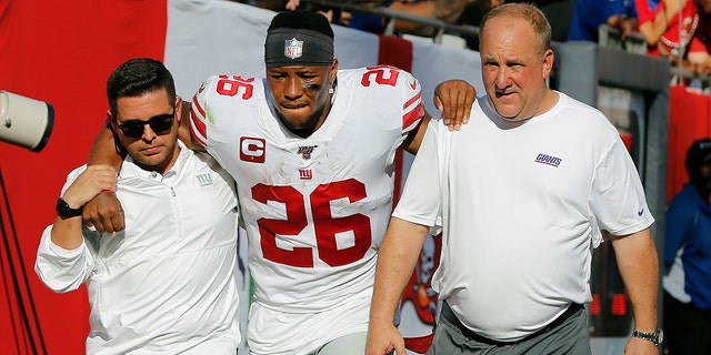 New York Giants running back Saquon Barkley (26) gets helped off the field after getting hurt against the Tampa Bay Buccaneers during the first half of an NFL football game Sunday, Sept. 22, 2019, in Tampa, Fla. (AP Photo/Mark LoMoglio)