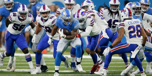 Detroit Lions running back Ty Johnson (38) is pursued by the Buffalo Bills' defense during the first half of an NFL preseason football game in Detroit, on Aug. 23, 2019. (AP Photo/Duane Burleson)
