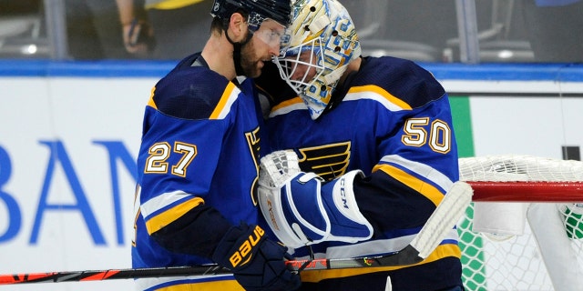 St. Louis Blues' Jordan Binnington (50) is congratulated by teammate Alex Pietrangelo (27) after their 5-3 victory over the Columbus Blue Jackets in an NHL preseason hockey game, Sunday, Sept. 22, 2019, in St. Louis. (AP Photo/Bill Boyce)