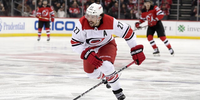 FILE - In this Feb. 10, 2019, file photo, Carolina Hurricanes defenseman Justin Faulk (27) is shown in action against the New Jersey Devils during the second period of an NHL hockey game, in Newark, N.J. (AP Photo/Julio Cortez, File)