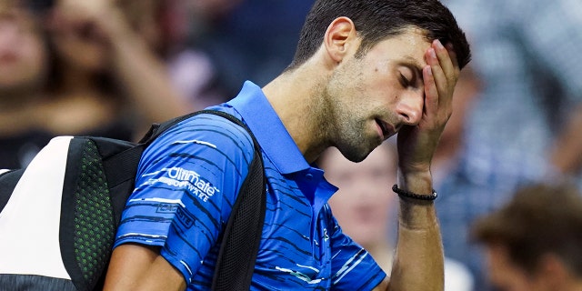 Novak Djokovic, of Serbia, walks off the court as he retires during his match against Stan Wawrinka, of Switzerland, during the fourth round of the U.S. Open tennis championships, Sunday, Sept. 1, 2019, in New York. (AP Photo/Eduardo Munoz Alvarez)