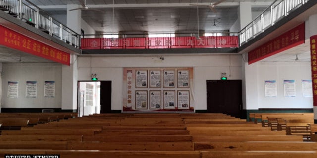 Political propaganda slogans and posters are posted throughout a Three-Self church.