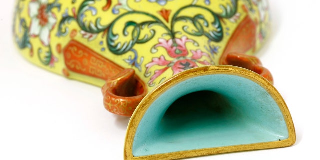 Unaware of its significance, the shopper listed the small yellow florally decorated vase on eBay to see if it was worth anything - only to be inundated with messages and bids. Realizing the pear-shaped vase, which is designed to be attached to a wall, must be valuable, he removed it from the bidding site and took it to specialists at Sworders Fine Art Auctioneers’ in Stansted Mountfitchet, Essex. (Credit: Sworders, BNPS)