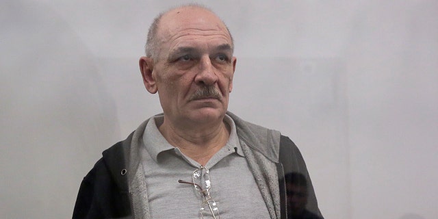 Volodymyr Tsemakh, suspected of involvement in the downing of the Malaysia Airlines flight MH17 plane in 2014, stands inside a defendants' cage during a court hearing in Kiev, Ukraine September 5, 2019.