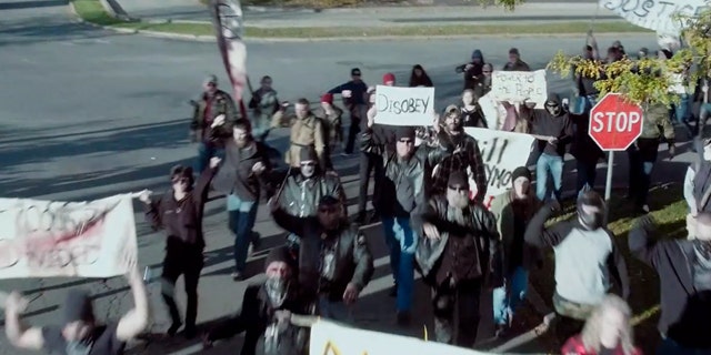 A still from the upcoming movie "The Reliant" featuring protesters rioting in a small U.S. town.