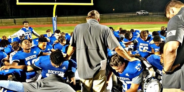 Rockvale High School Football Coach Rick Rice leads a team prayer, a practice that came under fire from the Freedom From Religion Foundation.