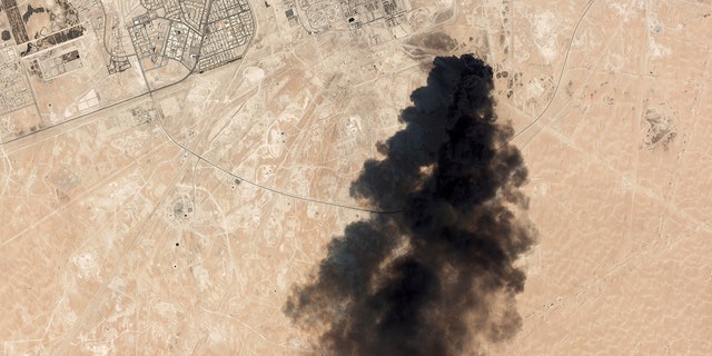 This Saturday, Sept. 14 satellite image from Planet Labs Inc. shows thick black smoke rising from Saudi Aramco's Abqaiq oil processing facility in Buqyaq, Saudi Arabia. (Planet Labs Inc via AP)