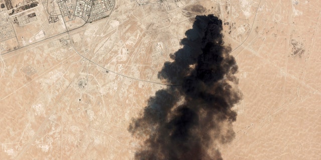 This Saturday, Sept. 14 satellite image from Planet Labs Inc. shows thick black smoke rising from Saudi Aramco's Abqaiq oil processing facility in Buqyaq, Saudi Arabia. (Planet Labs Inc via AP)