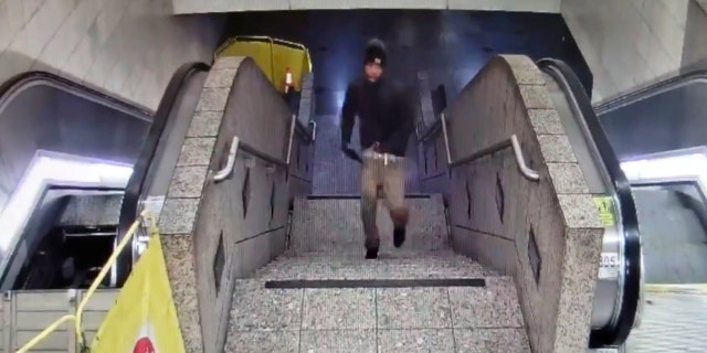 In this Friday night, Sept. 13, 2019, security camera video released by the Seattle Police Department, a suspect runs upstairs after a shooting at Westlake Station for Link light rail in Seattle.