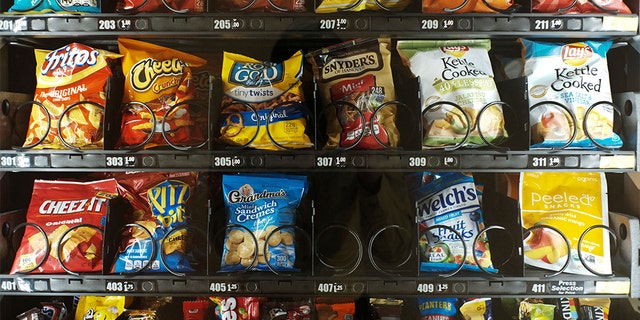 This Saturday, Sept. 7, 2019 photo shows items in a vending machine in New York. Americans are addicted to snacks, and food experts are paying closer attention to what that might mean for health and obesity. (AP Photo/Patrick Sison)