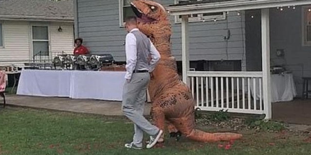 One confident maid of honor rocked an inflatable T-Rex costume to her sister’s recent wedding.