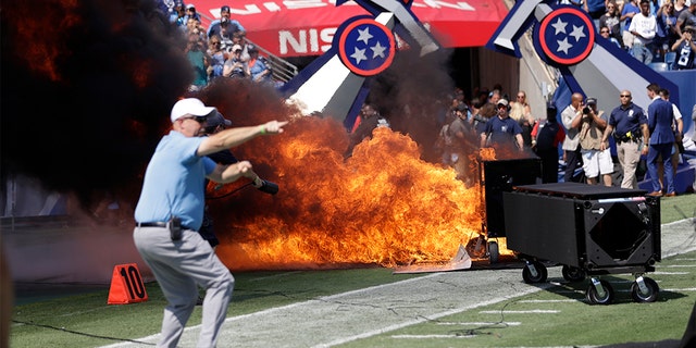 A fire from a pyrotechnics machine burning on the field before the game between the Tennessee Titans and the Indianapolis Colts on Sunday. (AP Photo/James Kenney)