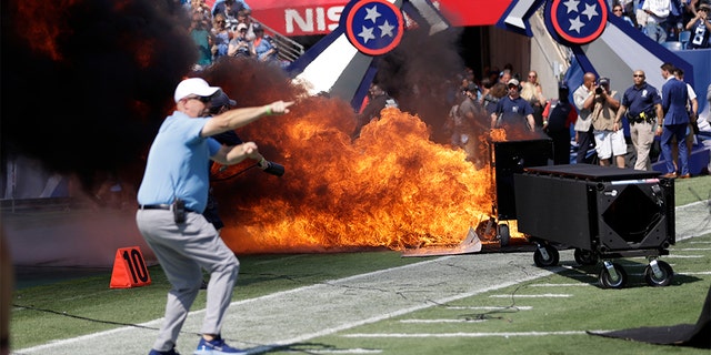 A fire from a pyrotechnics machine burning on the field before the game between the Tennessee Titans and the Indianapolis Colts on Sunday. (AP Photo/James Kenney)