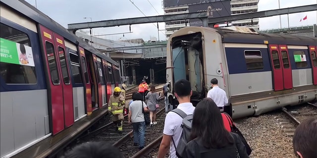 People and emergency crew at the site of the derailment in Hong Kong. (Facebook / @FCOOKINGHK via REUTERS)