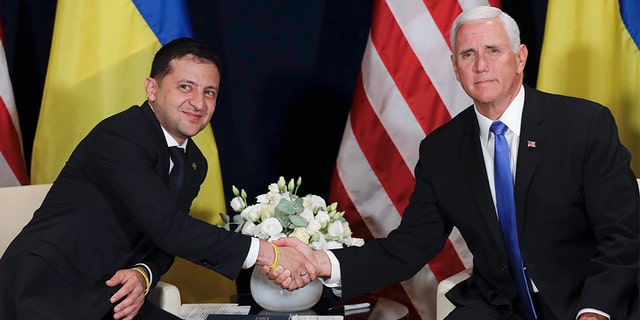 Ukraine's President Volodymyr Zelenskiy, left, shakes hands with U.S. Vice President Mike Pence, in Warsaw, Poland, Sunday, Sept. 1, 2019. (AP Photo/Petr David Josek)