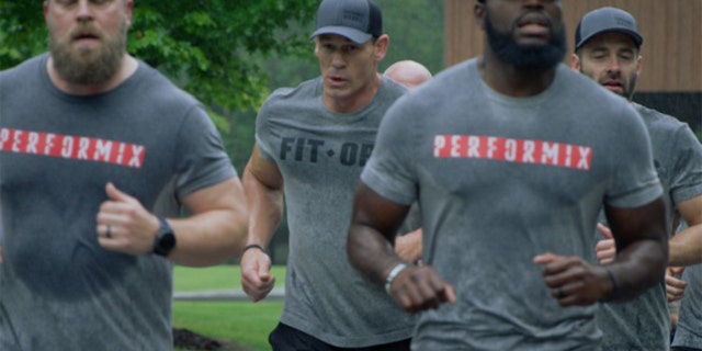 WWE star John Cena, center, said he and FitOps Foundation, sponsored through Performix, would match all donations until Veterans Day up to $1 million to help veterans returning from combat and keep them from committing suicide. FitOps was founded by Matt Hesse, the CEO of Performix and an Army veteran, far right. (FitOps Foundation)