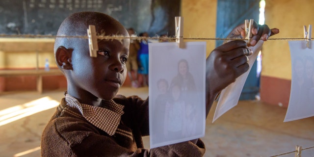 Elizabeth Mueke Kitonga looks for her sponsor as part of World Vision's "Chosen: Mwala Sponsorship Event."