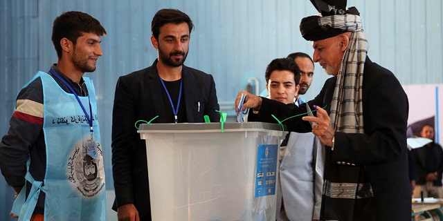 Afghan President Ashraf Ghani, right, casts his vote at Amani high school, near the presidential palace in Kabul, Afghanistan, Saturday, Sept. 28, 2019. Afghans headed to the polls on Saturday to elect a new president amid high security and Taliban threats to disrupt the elections, with the rebels warning citizens to stay home or risk being hurt. (AP Photo/Rahmat Gul)