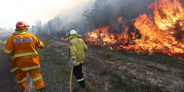 Firefighters battled bushfires in Angourie, northern New South Wales on Monday. AAP Image/Jason O'Brien/via Reuters