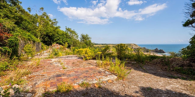 But the cabin was demolished - and the site overlooking Three Cliffs Bay on the stunning Gower Coast in Wales is now going under the hammer.