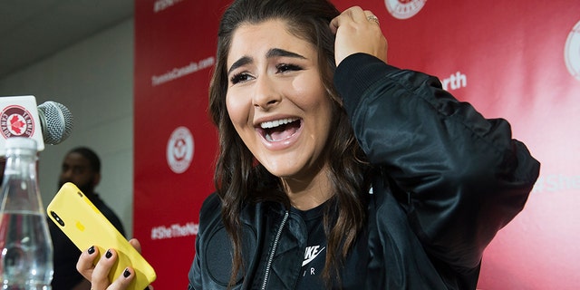 Canadian tennis player Bianca Andreescu laughs after reading a message from rapper Drake as she speaks to the media during a news conference. (Nathan Denette/The Canadian Press via AP)