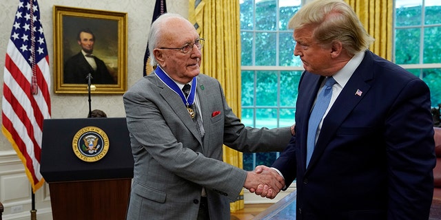 U.S. President Donald Trump greets Boston Celtics legend and Basketball Hall of Famer Bob Cousy prior to presenting Cousy with the Presidential Medal of Freedom to in the Oval Office of the White House in Washington, U.S., August 22, 2019. REUTERS/Kevin Lamarque - RC1A163A7F40