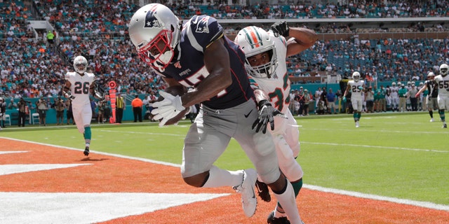 New England Patriots wide receiver Antonio Brown (17) scores a touchdown as Miami Dolphins cornerback Jomal Wiltz (33) attempts to defend on Sept. 15, in Miami Gardens, Fla. (AP Photo/Lynne Sladky)