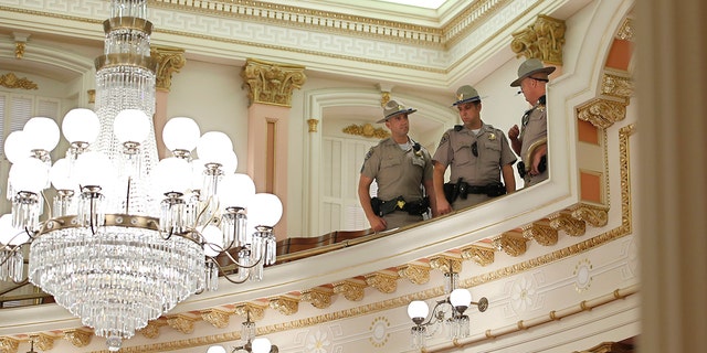 California highway patrolmen inspect the Senate Gallery after a red substance was thrown from the rostrum during the Senate sitting at Sacramento Capitol, California on Friday, Sept. 13, 2019. (AP Photo / Rich Pedroncelli )