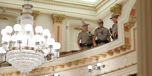 California highway patrolmen inspect the Senate Gallery after a red substance was thrown from the rostrum during the Senate sitting at Sacramento Capitol, California on Friday, Sept. 13, 2019. (AP Photo / Rich Pedroncelli )