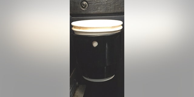 An image of the coffee, photographed here in a cupholder, is reversed and landed the plane. 