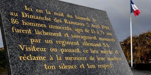 A commemorative plaque is placed in the village of Ascq, in northern France, to remember the April 1944 massacre of 86 people by Nazis.