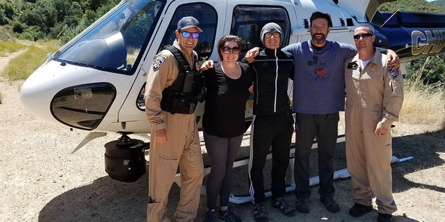 Krystal Ramirez, Hunter Whitson and Curtis Whitson, pictured with California Highway Patrol officials, were thankful to be rescued from an isolated tributary by sending an SOS message in a plastic Nalgene water bottle in June.