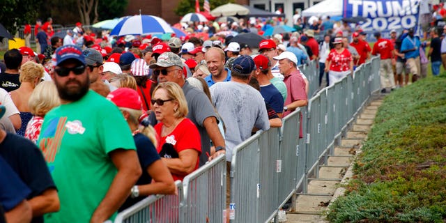 Attendees line up outside hours before President Donald Trump speaks at a campaign rally in Fayetteville, N.C., Monday Sept. 9, 2019 (AP Photo/Chris Seward)