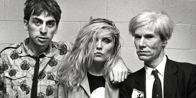 Chris Stein, Debbie Harry, and Andy Warhol pose ahead of a Blondie concert at the Meadowlands in New Jersey in August 1982.