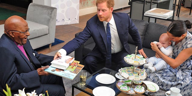Britain's Duke and Duchess of Sussex, Prince Harry and his wife Meghan hold their baby son Archie as they meet with Archbishop Desmond Tutu.