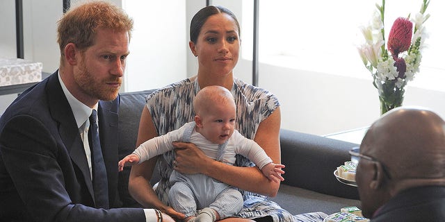 Britain's Duke and Duchess of Sussex, Prince Harry and his wife Meghan hold their baby son Archie as they meet with Archbishop Desmond Tutu at the Tutu Legacy Foundation in Cape Town on September 25, 2019.