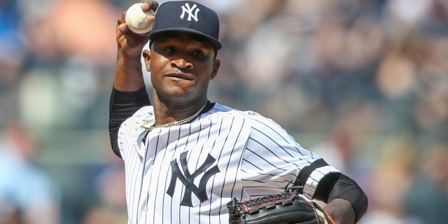 FILE - This is an Aug. 31, 2019, file photo showing New York Yankees pitcher Domingo German throwing to first in a pickoff attempt during the fifth inning of a baseball game against the Oakland Athletics, in New York. (AP Photo/Mary Altaffer, File)