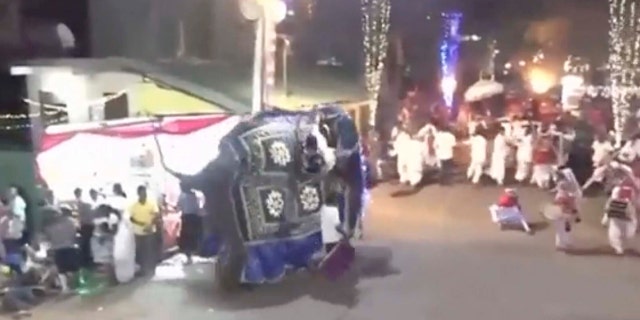 This frame from a Saturday, Sept.7, 2019 video provided by Derana Television, shows drummers running for cover as an elephant runs berserk during a Buddhist pageant in Kotte, near Colombo, Sri Lanka.