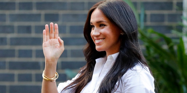 Meghan, the Duchess of Sussex, waves as she leaves a department store after launching the Smart Works capsule collection in London.
