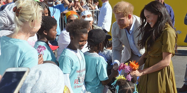 Britain's Prince Harry, and his wife, Meghan, the Duchess of Sussex, during a walkabout in Bo-Kaap, a heritage site, in Cape Town, South Africa, Tuesday, Sept, 24, 2019. (Courtney Africa / African News Agency via AP, Pool)