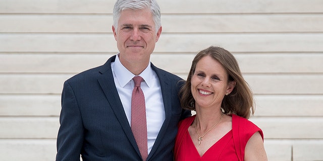 Justice Neil Gorsuch stands with his wife Marie Louise Gorsuch on the steps of the U.S. Supreme Court in Washington, D.C., June 15, 2017.