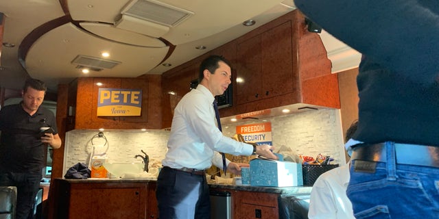 Pete Buttigieg grabs a cup of coffee while traveling across Iowawith reporters by bus. (Mitti Hicks/Fox News)