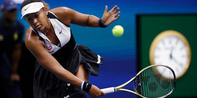 Naomi Osaka, of Japan, returns against Belinda Bencic, of Switzerland, during the fourth round of the US Open tennis championships. (AP Photo/Frank Franklin II)