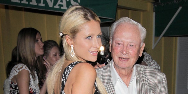 Paris Hilton dines at Dan Tana with her grandfather, Barron Hilton, in 2014. (Photo by Philip Ramey / Corbis via Getty Images)