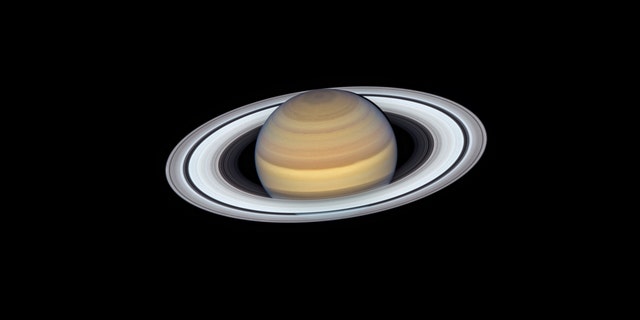 The latest view of Saturn from NASA's Hubble Space Telescope captures exquisite details of the ring system — which looks like a phonograph record with grooves that represent detailed structure within the rings — and atmospheric details that once could only be captured by spacecraft visiting the distant world.