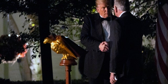 President Trump shakes hands with Australian Prime Minister Scott Morrison in the Rose Garden Friday night. (AP Photo/Jon Elswick)