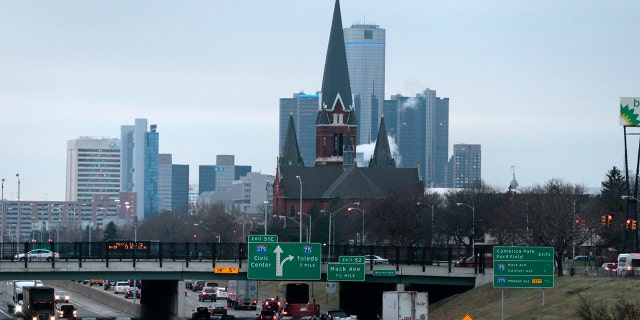 Traffic moves along a highway toward downtown Detroit, Michigan, U.S., on Wednesday, Dec. 10, 2014.