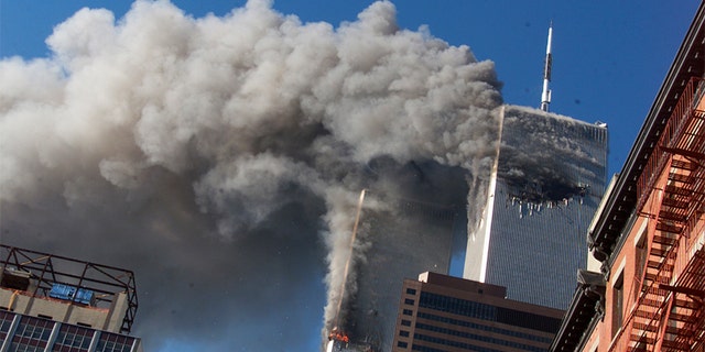 Smoke rises from the burning twin towers of the World Trade Center after hijacked planes crashed into the towers in New York City on Sept. 11, 2001. (AP)