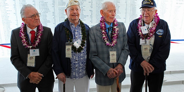 USS Arizona survivors(L to R) Donald Stratton, Louis Conter, John Anderson and Lauren Bruner pose for a picture in front of the Remembrance Wall on the USS Arizona Memorial during ceremonies honoring the 73rd anniversary of the attack on Pearl Harbor at the World War II Valor in the Pacific National Monument in Honolulu, Hawaii December 7, 2014.